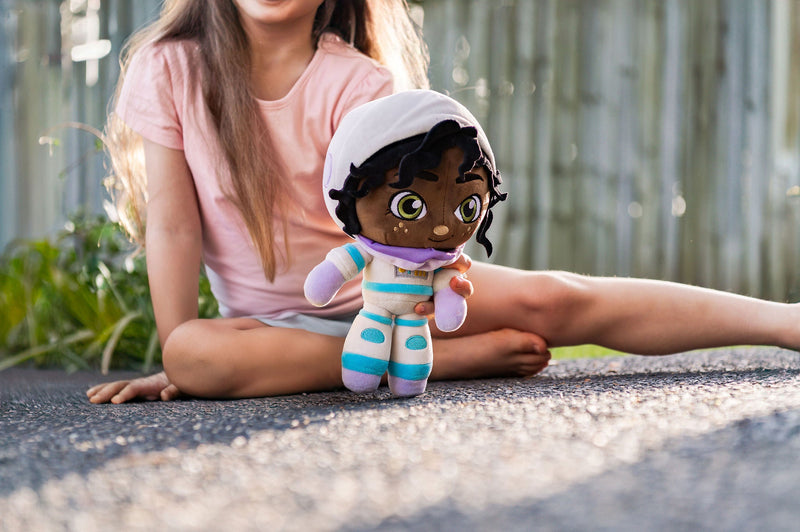 girl plays with astronaut plush toy