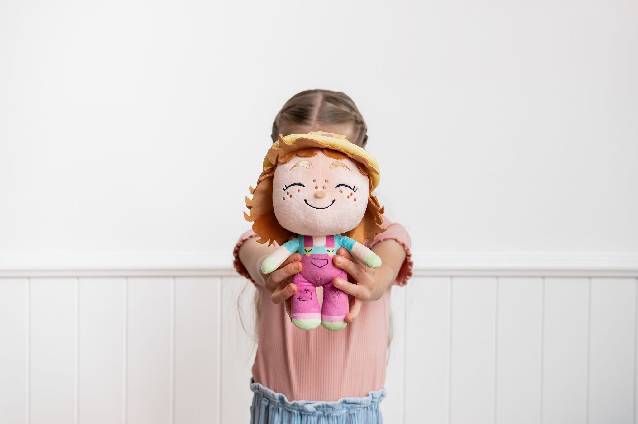 Child playing with Gloria Gardener doll indoors - nurturing and caring career toy for kids 3+