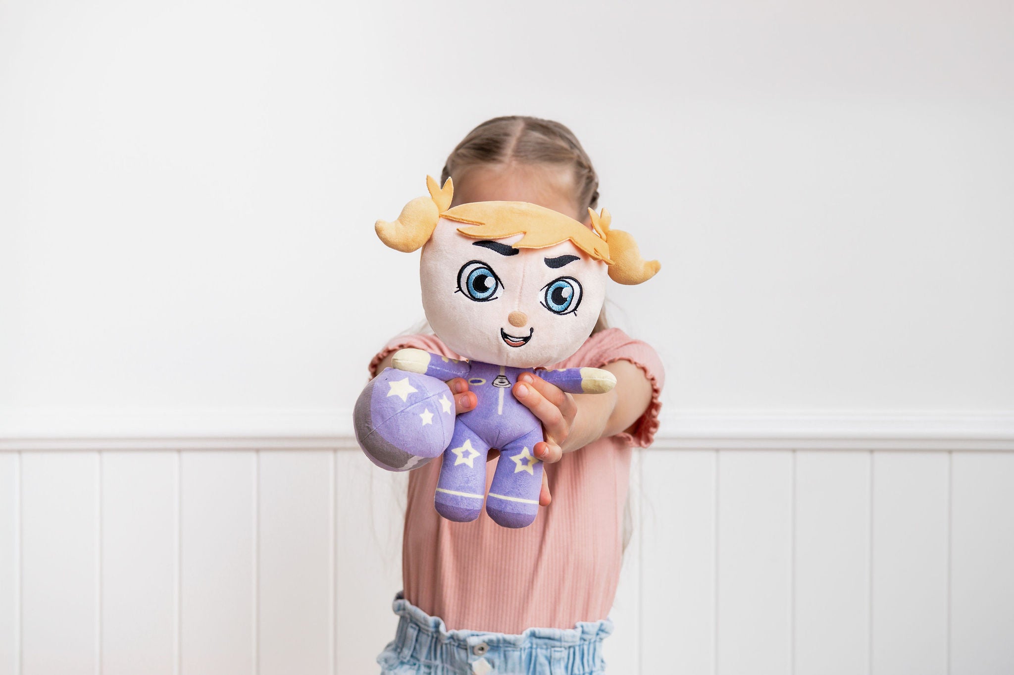 Rosie Racer doll in racing gear indoors - self-confidence building toy that lifts others up