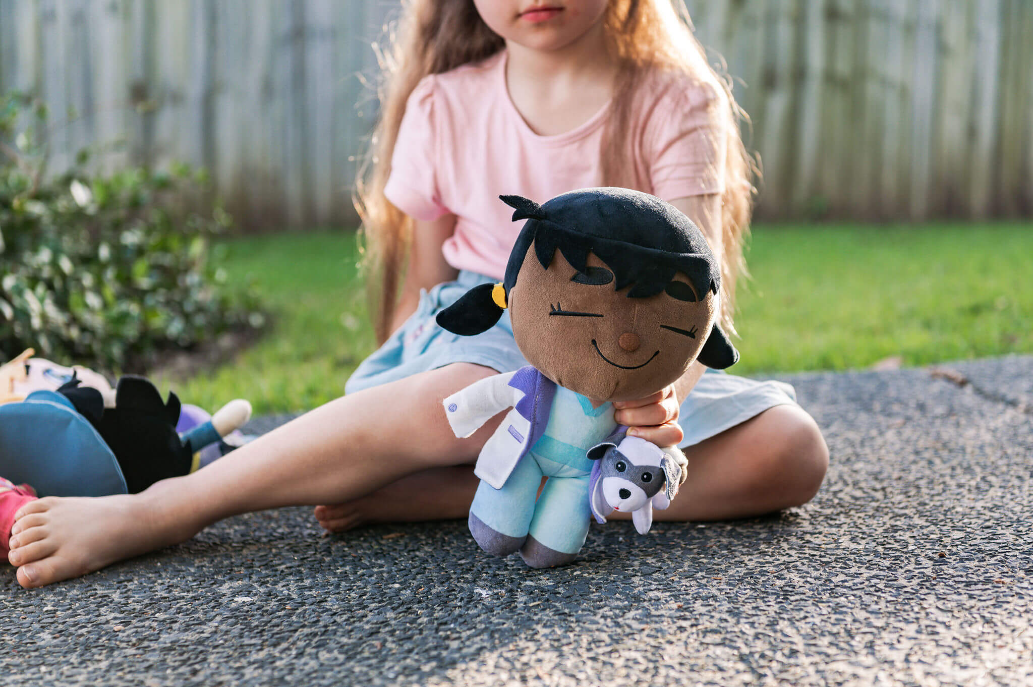 Child playing with Venus Vet plush in outdoor setting