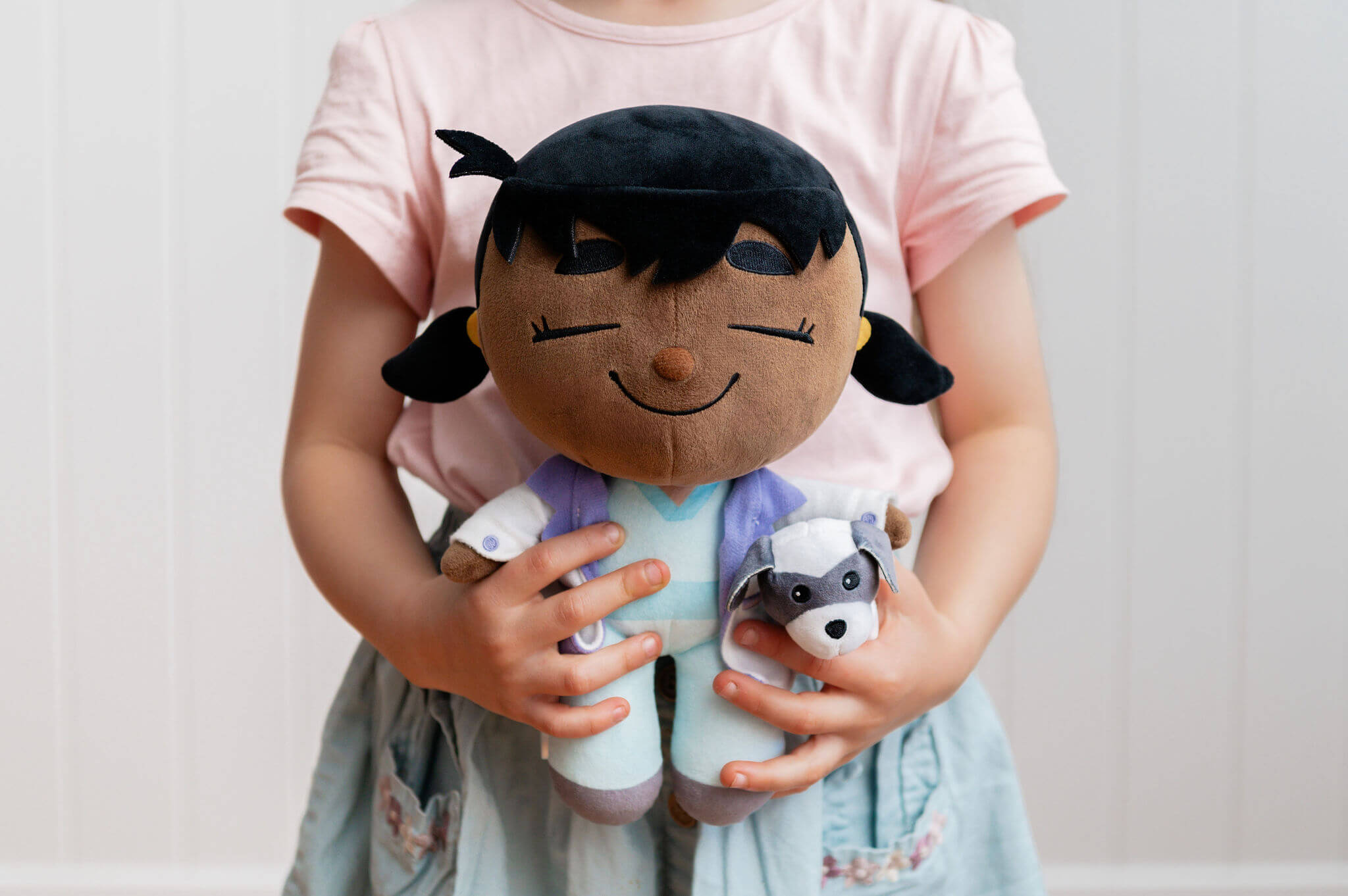 Child playing with Venus Vet plush in indoor setting