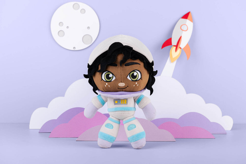 Aria Astronaut plush doll in a paper-crafted space scene with a moon and rocket.